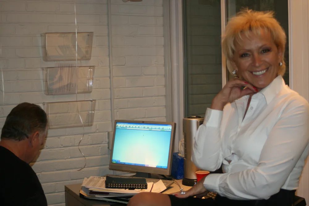 An Excel team member at the front desk in the office.