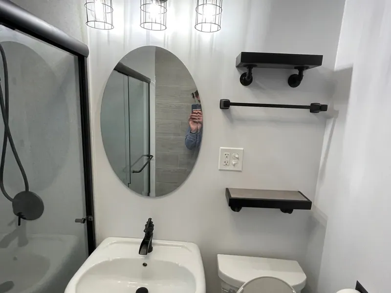 Matte-black Moen faucet and hardware over a white sink — one of the finishes Excel installs