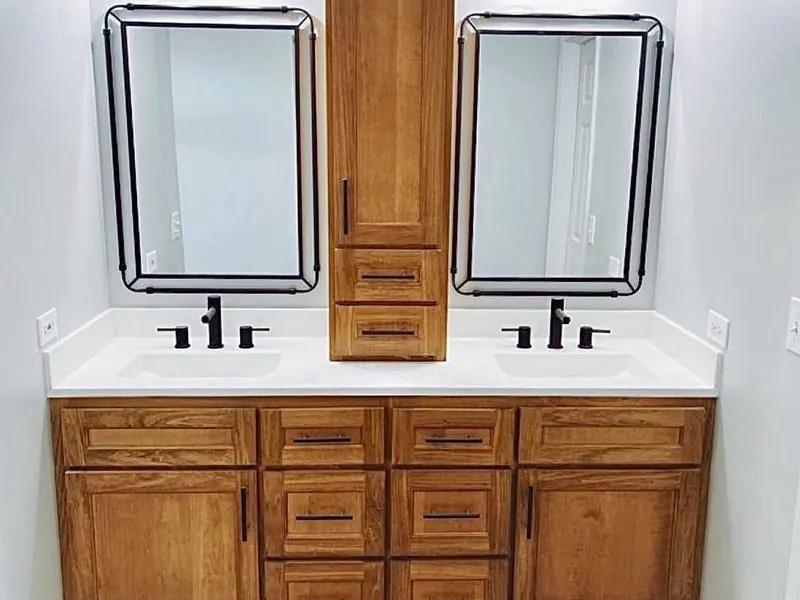 Traditional oak double vanity with a stone top — one of many cabinetry styles, custom-built by Brothers Leal