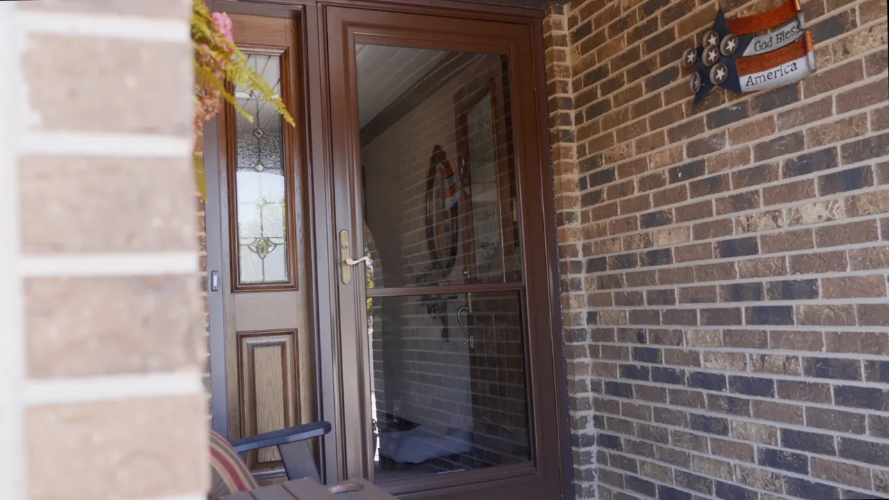A full-view glass storm door over a glass-insert entry door on a brick south-suburb home, an Excel install