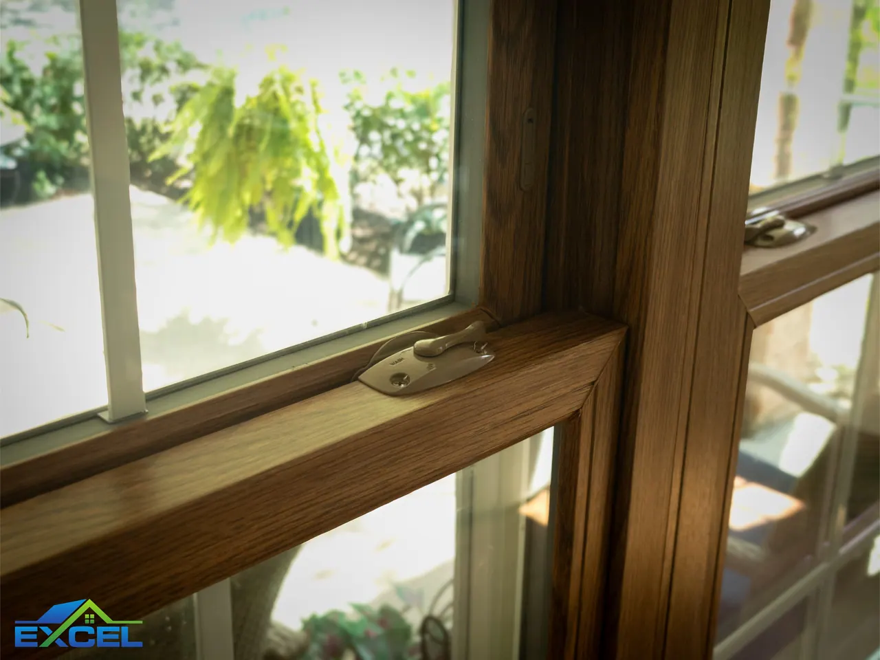 Close-up of an oak-finish sash corner and lock
