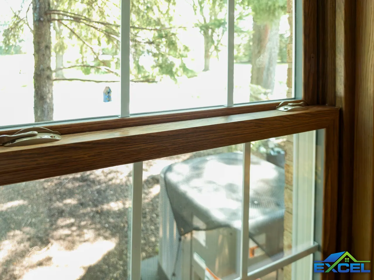 Close-up of an oak-finish double-hung sash and lock