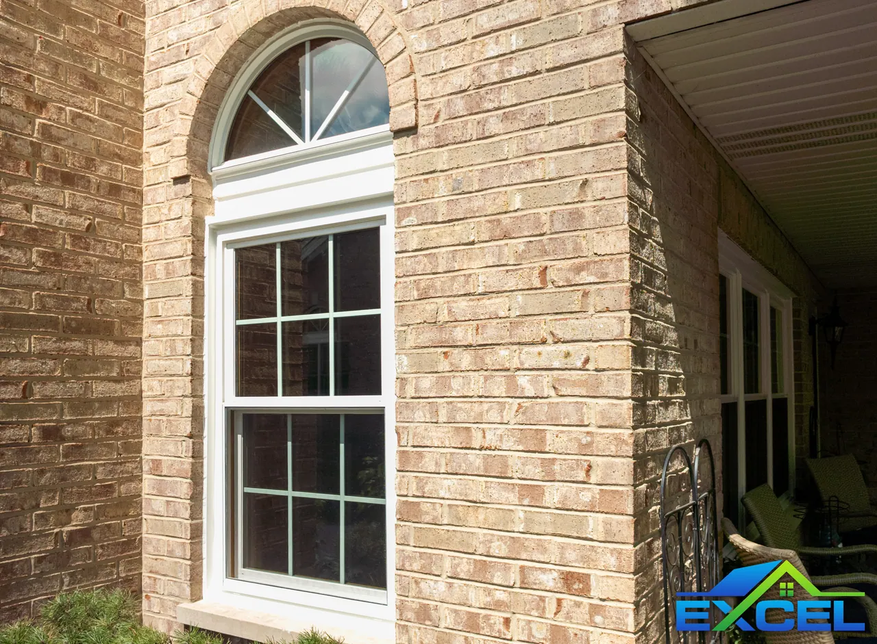 Arched-top double-hung window in a brick wall