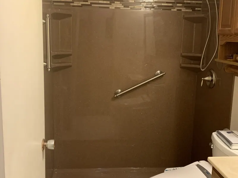 Finished walk-in shower with a marble-look solid-surface surround and a grab bar, an Excel install in the south suburbs