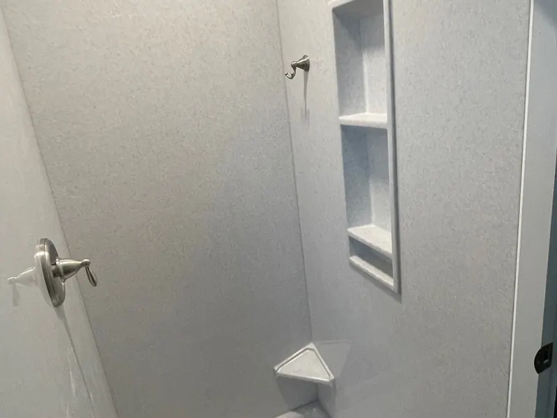Finished walk-in shower with seamless solid-surface walls and brushed-nickel fixtures, an Excel install in the south suburbs